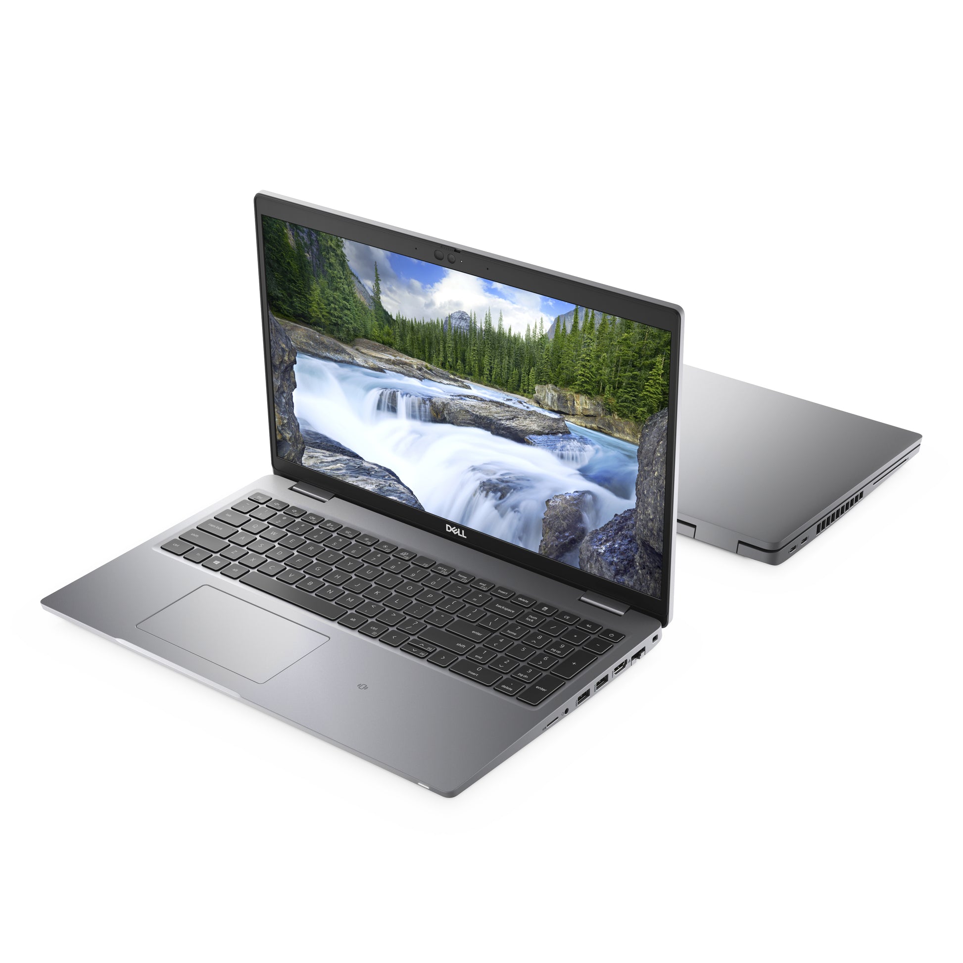 Dell laptop open and closed, grey color, with waterfall nature wallpaper on screen